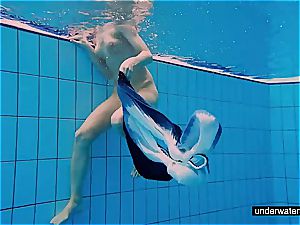 nubile woman Avenna is swimming in the pool