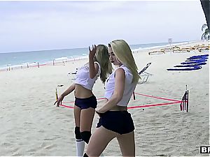 three teenager bombshells catch a large cumbot on the beach